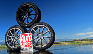 Three wheels stacked behind Auto Express tyre test logo